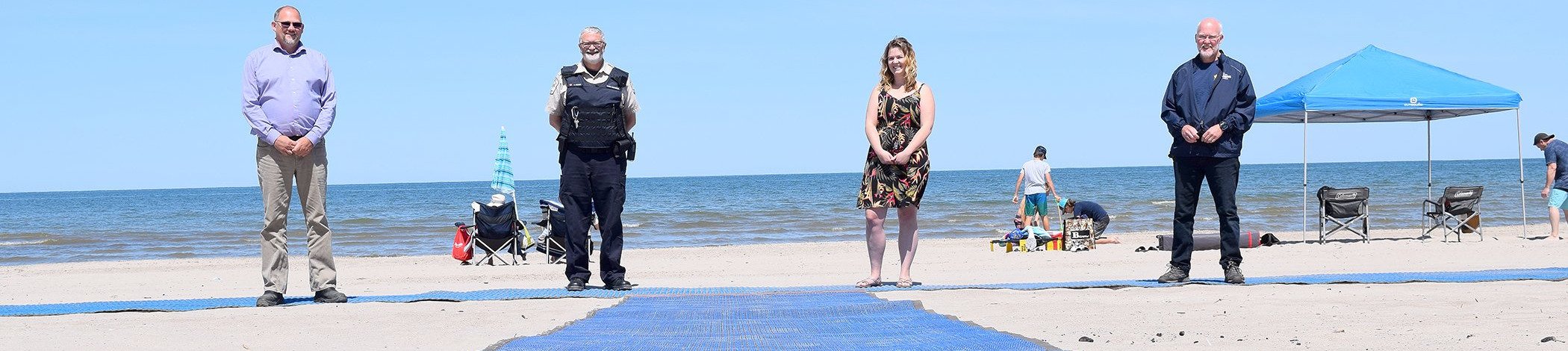 Town staff and parks staff on beachfront with Mobi-Mat